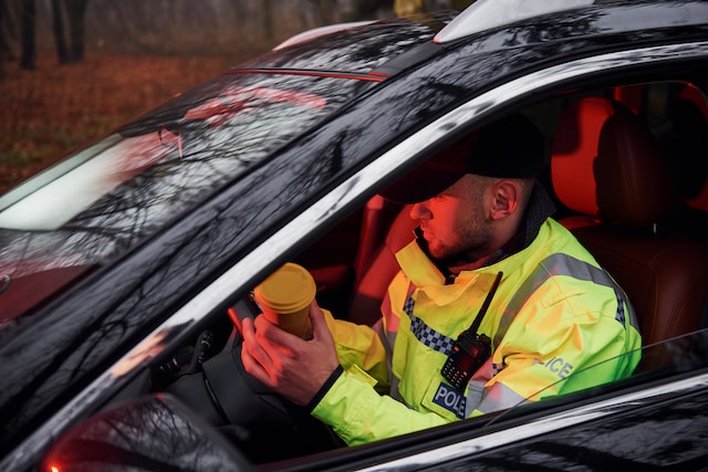 Police officer sat in car